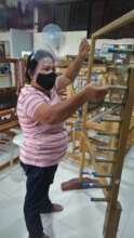 Celia Tribunal doing warping of thread in Weaving