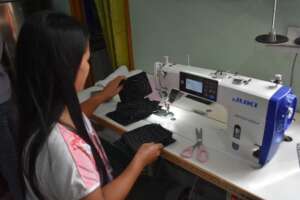 A trainee sewing various patterns in her training