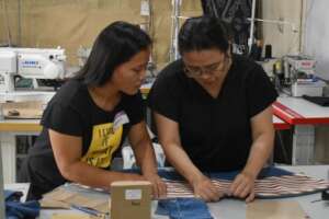 Ms. Joy Barcelona of DAWN assists a sewing trainee