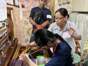 Ms. Biong teaching student and faculty to weave