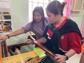 Ms. Gile teaching a BPI Team member to weave