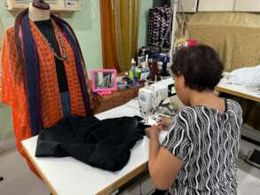 Ms. Marife Patino sewing a bag