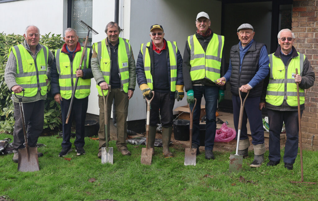 The crocus planting team 'presents arms'