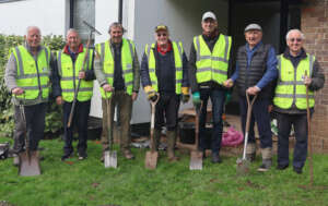 The crocus planting team 'presents arms'