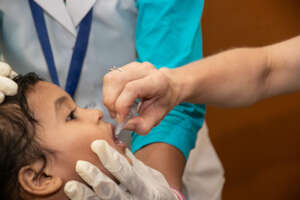 Child receiving Polio vaccine at a health centre