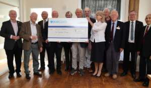 Club members presenting cheque to Smile Train