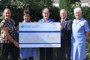 Club Secretary Brian presents cheque to St Luke's