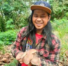 Our head farmer holding shiitake mushrooms
