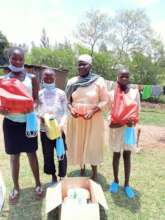 A Caregiver with Her Children & Food Supplies