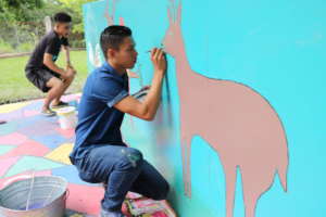 Mural painting in progress by community members