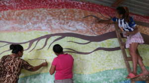 Mothers join a library mural painting day