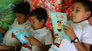 Students reading their first children's books
