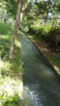 The open ditch the water travels to schools