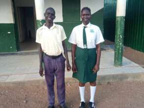 James and Nyamuch outside of their school
