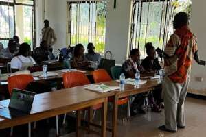 Dr. Mgembe speaks to the group