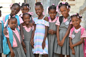 Alexa (center) returns to school.