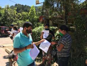 Victor handing out cooking and health guides