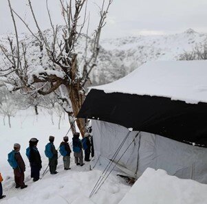 Afghan children outside a snowy Learning Centre