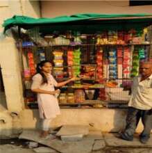 Dinesh at his shop with his customers