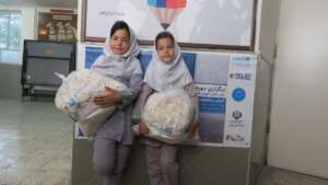 Children receiving school and hygine kits
