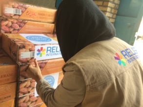 RI staff preparing shipments of goods for refugees