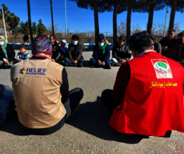 RI Staff talking with a group of Afghan refugees