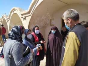RI Staff talking with Afghan Refugees.