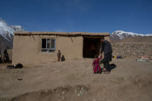 Sayed and his children outside their home