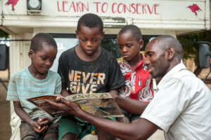 Community Educator reading the Kalata magazine