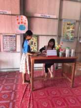 Librarian and young reader at our first library