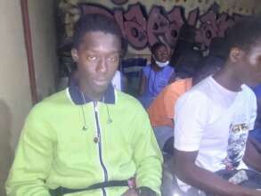 Fallou learning English at the Diapalante Centre