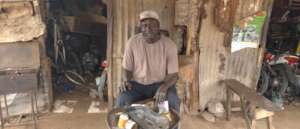 Makhtar at his motorbike-taxi repair workshop