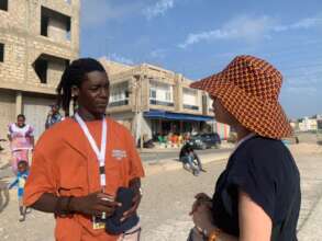 Fallou talks to a visitor to the dance studio
