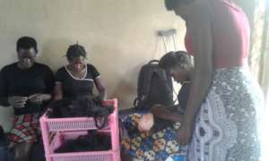 Hair dressing trainees with their tutor in class