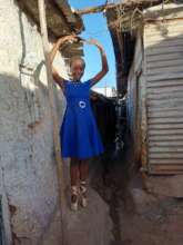Brenda infront of her house.