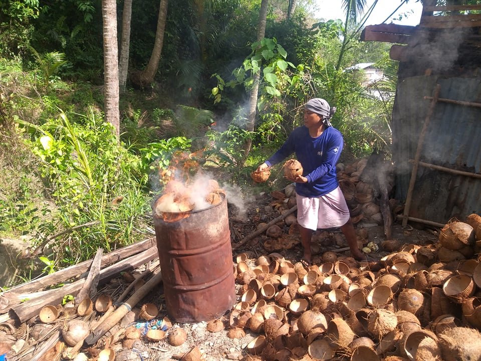 Coconut Farmer making charcoal