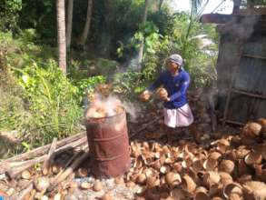 Coconut Farmer making charcoal