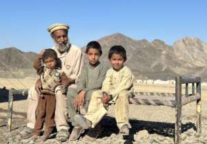 A family sits in the Torkham camp.