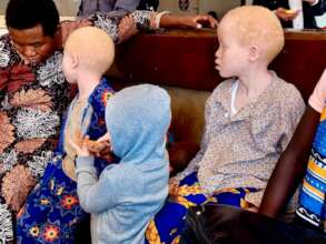 Children wait with their mother for skin checks