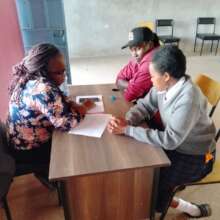Connie counselling a parent and child at school