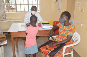 Health worker reviewing a patient
