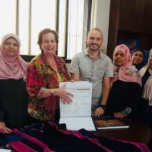 Presenting our embroidery book to the artisans