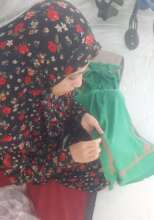 Gazan embroiderer at the displacement shelter