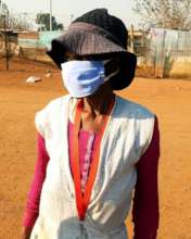 Gogo in the village with her mask