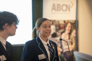 Yr 1 Scholar Sophia emceeing at Leadership Summit