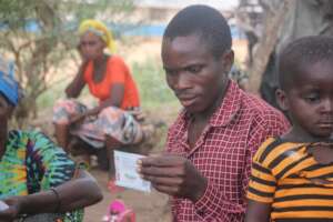 A man examines a newly distributed seed packet.