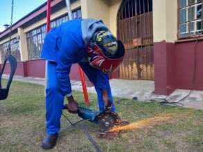 Apprentice welder working at Ekwetsembeni School