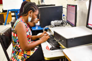 A Computer Repair and Maintenance trainee at work