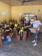 Volunteer handing out biscuits