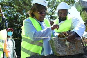MP, Honorable Jane Kihara, helps with foundation.